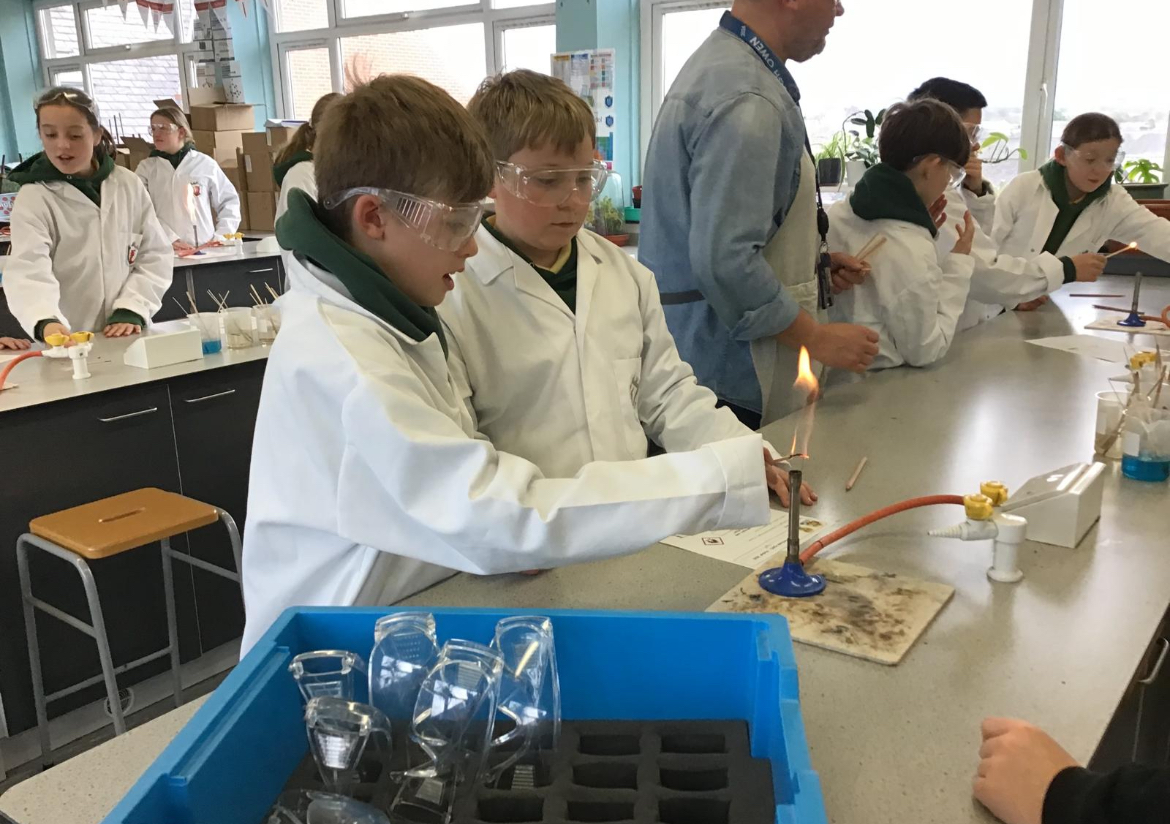 2 students using a bunsen burner