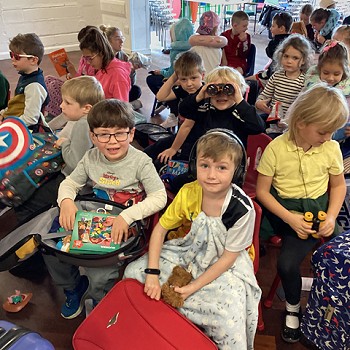 grŵp o fyfyrwyr yn eistedd yn y neuadd