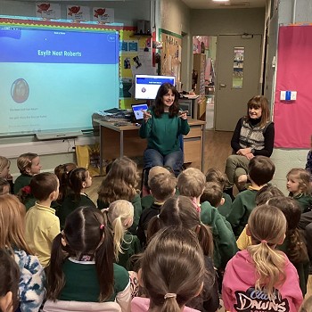 Esyllt Nest Roberts sitting in front of a classroom full of pupils