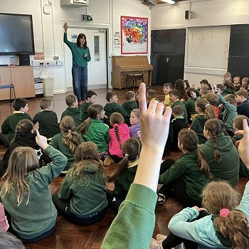 Esyllt Nest Roberts with here hand up in front of a classroom full of pupils