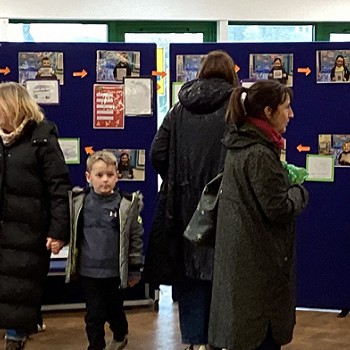students relatives looking at their art work