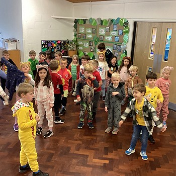 Group of children enjoying themselves dancing in the hall
