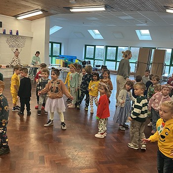 Children dancing with each other in the hall