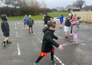 Children learning listening skills in the schoolyard