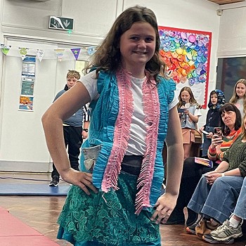 A child posing while showcasing her colourful clothes