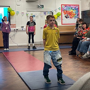 A child walking down showing his clothes