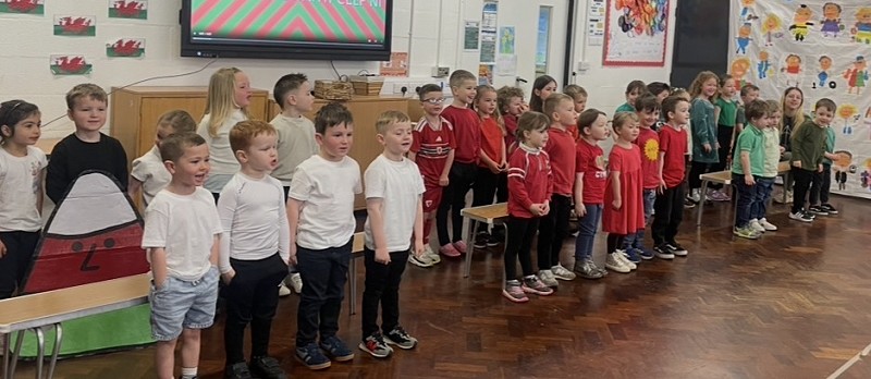 Group of Nursery and reception wearing whit, red and green t-shirts